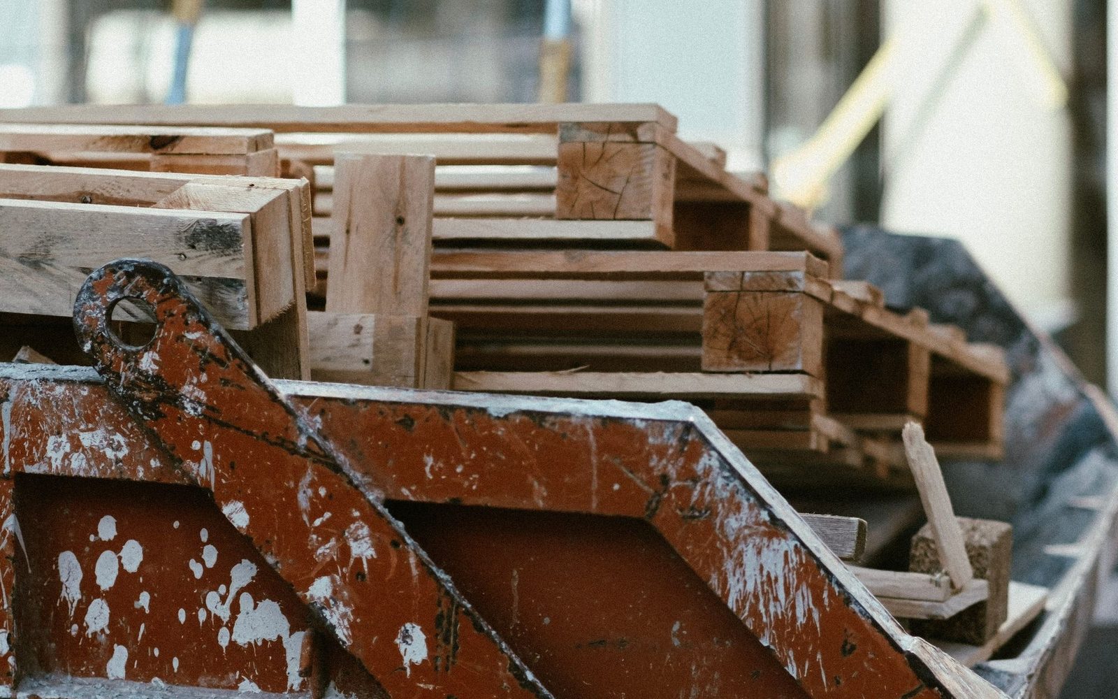 Paint-splashed builders skip loaded with timber offcuts on a building site