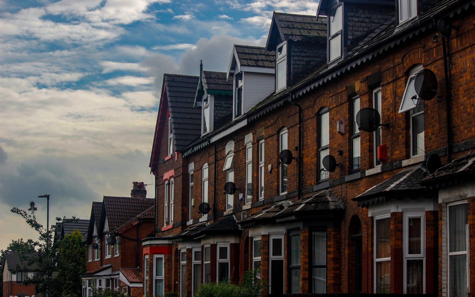 Row of Victorian brick terraced houses on a street with no off-street parking